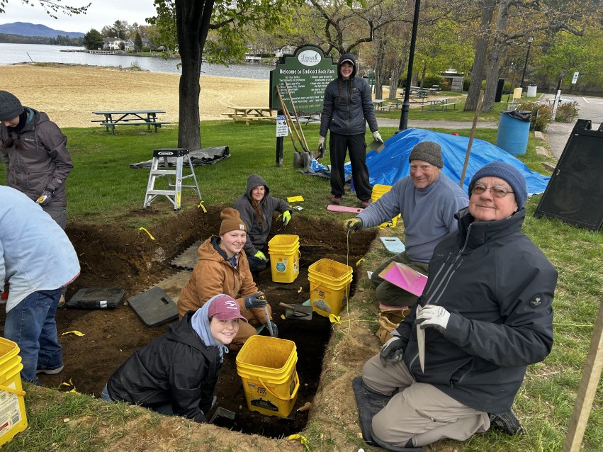 Archaeology students and instructors work in an excavation unit at Weirs Beach in New Hampshire during field school.