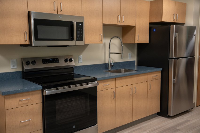 new kitchen with wood cabinets and blue countertops
