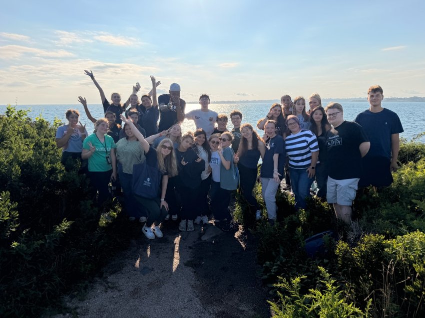 Students pose along the waterfront at Norman Bird Sanctuary.