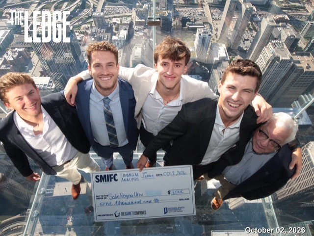 Four students and a professor in front of backdrop of Chicago's Willis Tower.