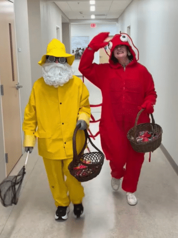 Two people dressed up as a lobster and a fisherman.