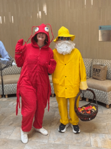 Two people dressed up as a lobster and a fisherman.