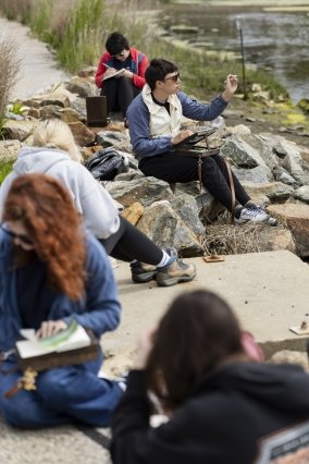 Students using their landscape as inspiration for their sketchbook creations.