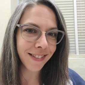 Selfie of Crowley-Watson smiling with glasses on.