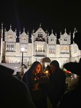 History Club PR coordinator Sydney Dufresne '25 sharing the haunted history of Salve's Gerety Hall during the ghost tour.