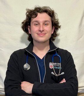 Photo of Silva smiling with black jacket on and stethoscope around his neck.