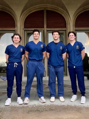 Benjamin Silva '24 (left) and other nursing students in their Salve scrubs.