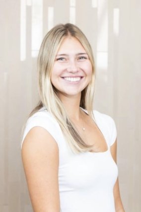 Blonde female student in white shirt, smiling