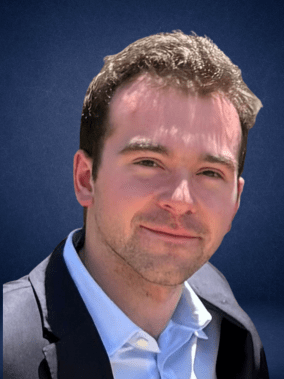Headshot, brown-haired student in blue shirt and jacket