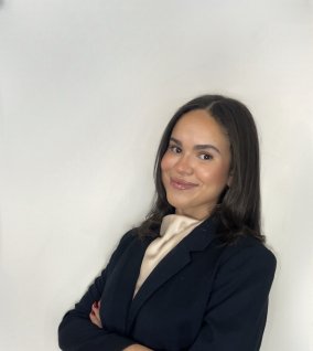 Brunette female student in business attire, smiling