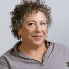 Professional headshot of Kaplan in front of gray backdrop.