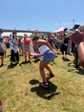 Jazz dancer inside a circle of dancers performing outdoors