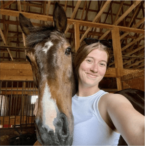 young woman taking a selfie with a horse