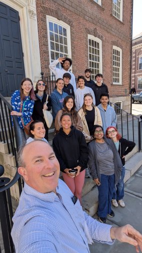 Dr. Tim Neary with students outside the Newport Colony House.