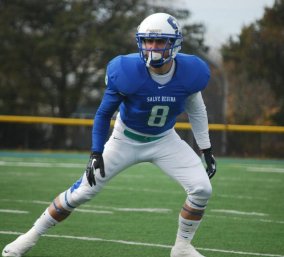 Football player on the field wearing number eight.