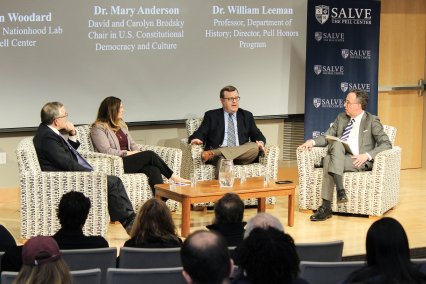 People talking while seated on stage