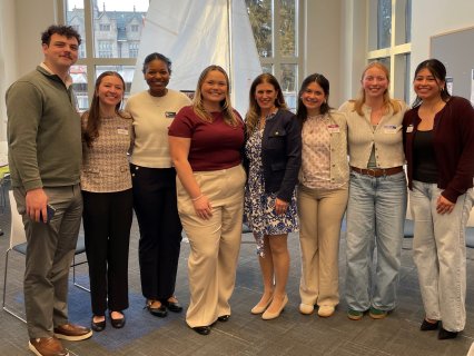 Professor and students stand together 