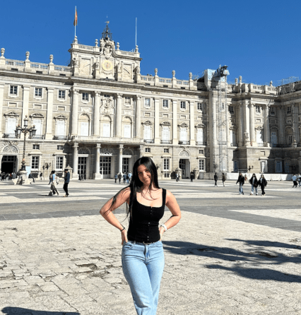 Meier standing and smiling in front of a historic building.
