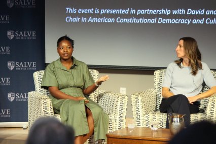 Two panelists on stage at Pell Center event 