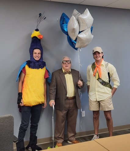 Three people dressed as characters from "Up".