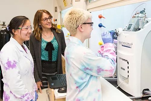 Professor Susan Meschwitz with two chemistry students