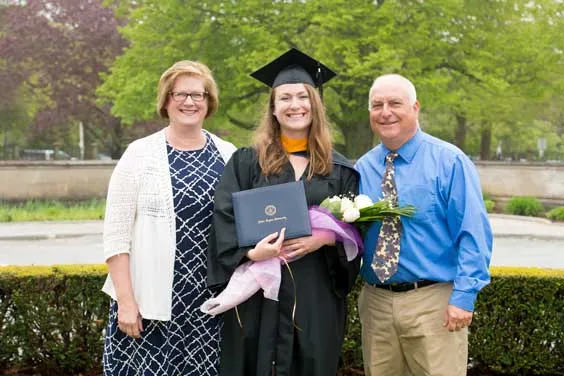 mother and father with daughter at commencement